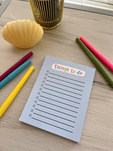 Blue to do list that says 'things to do.' perfect for writing down daily tasks and staying organized. simple and cute stationery product. 